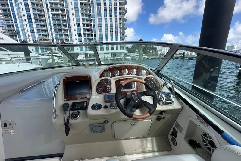 Slide: The Image of Helm of 2008 Sea Ray 340 Sundancer with cityscape and marina view. - 31