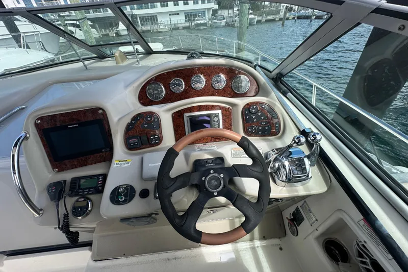Slide: The Image of Cockpit of 2008 Sea Ray 340 Sundancer with steering wheel and control panel. - 32