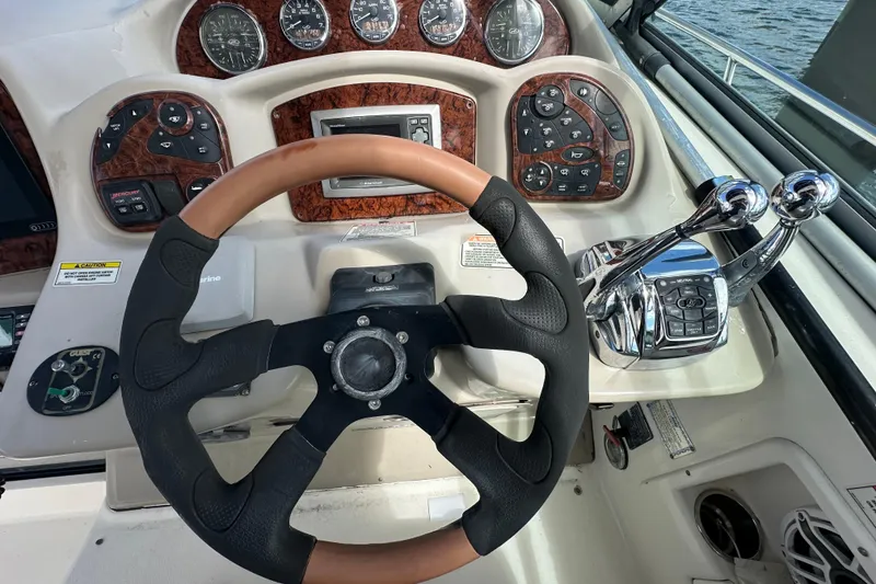 Slide: The Image of Steering wheel and controls of 2008 Sea Ray 340 Sundancer boat cockpit. - 33