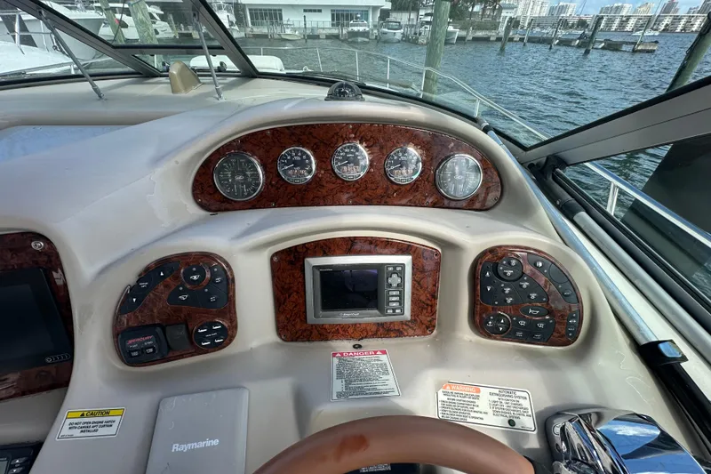 Slide: The Image of Helm of 2008 Sea Ray 340 Sundancer with gauges and controls, docked by the water. - 35