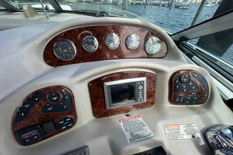 Slide: The Image of 2008 Sea Ray 340 Sundancer dashboard with gauges and controls, overlooking marina. - 37