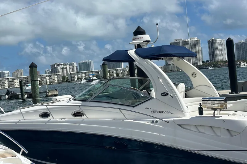 Slide: The Image of 2008 Sea Ray 340 Sundancer yacht docked with city skyline in background. - 4
