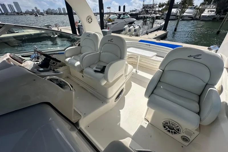 Slide: The Image of 2008 Sea Ray 340 Sundancer cockpit with plush seating, docked at marina. - 40