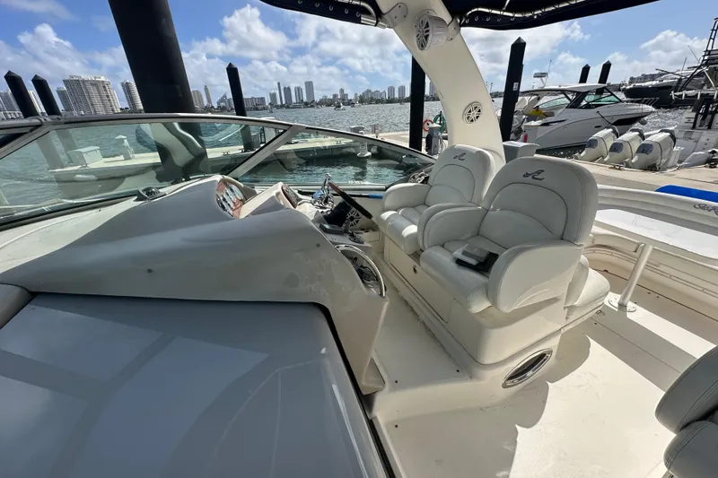 Slide: The Image of 2008 Sea Ray 340 Sundancer cockpit with dual seats, docked in a marina under blue skies. - 41