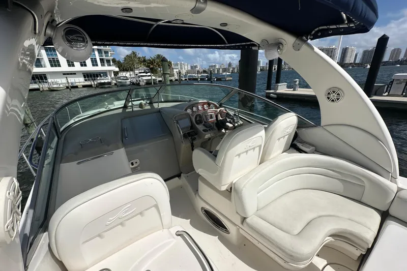 Slide: The Image of 2008 Sea Ray 340 Sundancer cockpit with luxurious seating and modern controls at marina. - 49
