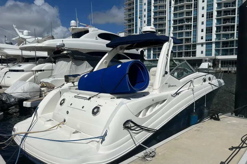 Slide: The Image of 2008 Sea Ray 340 Sundancer yacht docked at marina with modern buildings in background. - 5