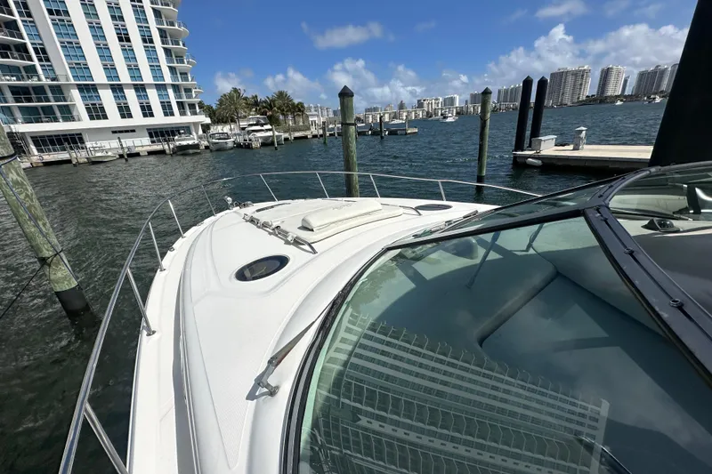 Slide: The Image of 2008 Sea Ray 340 Sundancer yacht docked in a marina with cityscape background. - 53
