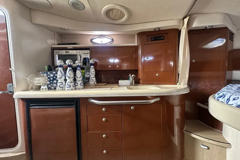 Slide: The Image of 2008 Sea Ray 340 Sundancer interior kitchen with wooden cabinets and countertop. - 55