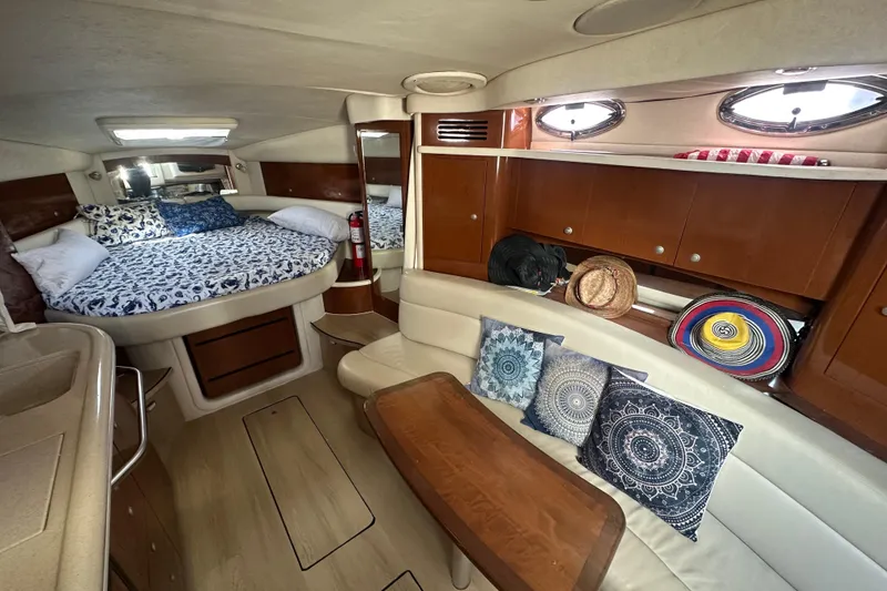 Slide: The Image of Interior of 2008 Sea Ray 340 Sundancer with cozy bed, seating, and decorative pillows. - 62
