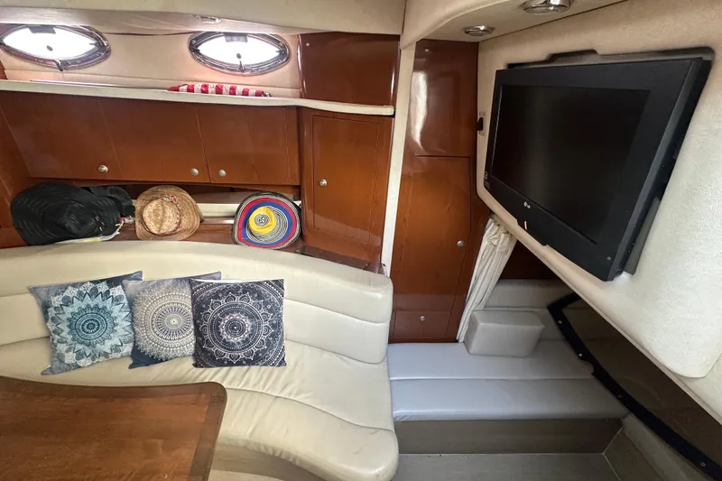 Slide: The Image of Interior of 2008 Sea Ray 340 Sundancer with cushions, TV, and wooden cabinets. - 63
