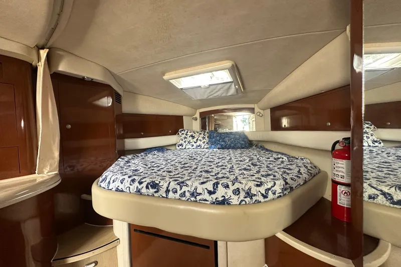 Slide: The Image of Luxurious cabin interior of 2008 Sea Ray 340 Sundancer with cozy bed and elegant wood finish. - 74