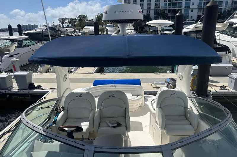 Slide: The Image of 2008 Sea Ray 340 Sundancer yacht with blue canopy docked at marina. - 76