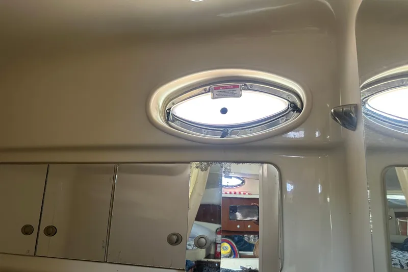 Slide: The Image of Interior of 2008 Sea Ray 340 Sundancer with oval porthole and storage cabinets. - 80