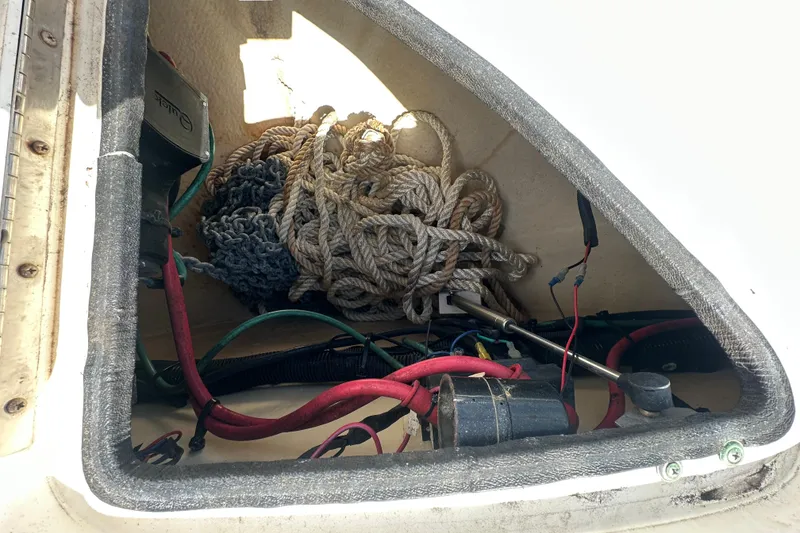 Slide: The Image of Storage compartment of a 2008 Sea Ray 340 Sundancer with ropes and electrical components. - 82