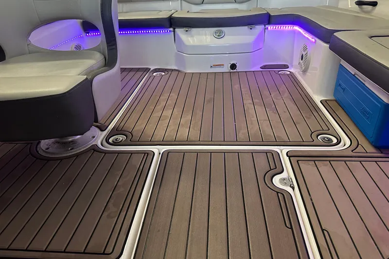 Slide: The Image of 2020 Yamaha Boats AR190 interior with wood-style flooring and ambient lighting. - 6