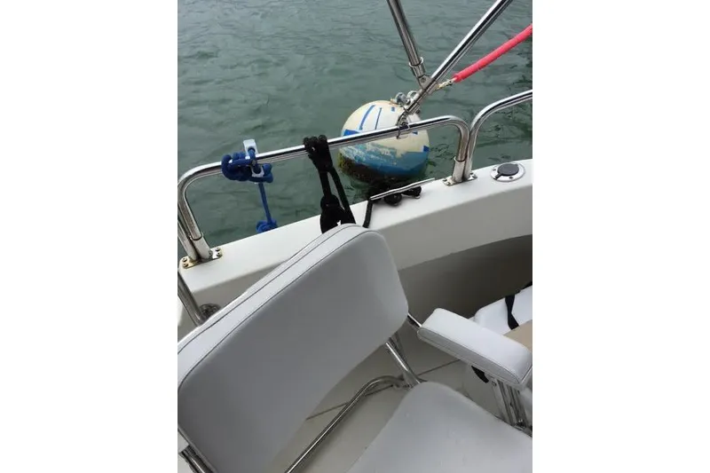 Slide: The Image of 2007 Ranger Tugs R-25 SC boat interior with mooring buoy in water. - 13