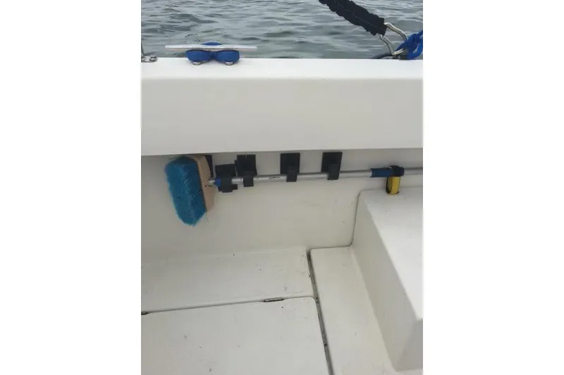 Slide: The Image of 2007 Ranger Tugs R-25 SC boat interior with cleaning brush and sunglasses on deck. - 14