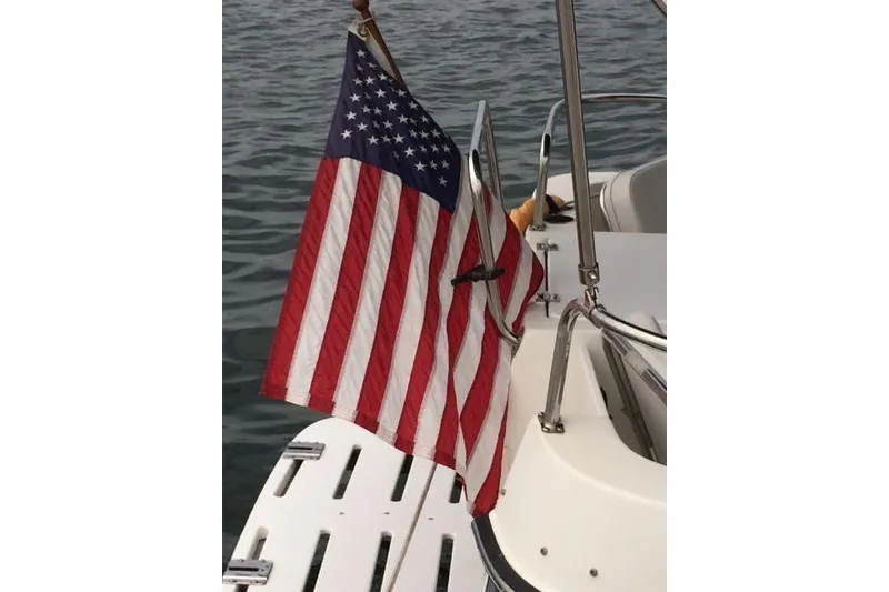 Slide: The Image of American flag on a 2007 Ranger Tugs R-25 SC boat, near water. - 17