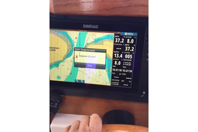 Slide: The Image of Simrad navigation display on 2007 Ranger Tugs R-25 SC showing a dangerous vessel alert. - 25