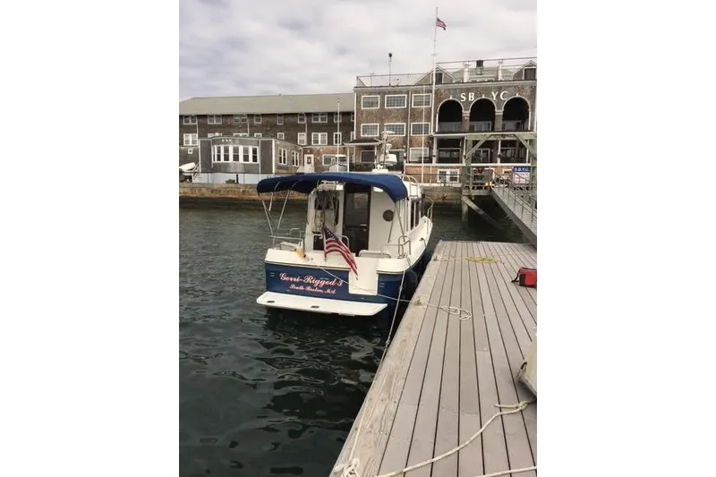 Slide: The Image of 2007 Ranger Tugs R-25 SC docked at marina with American flag. - 3