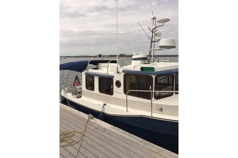 Slide: The Image of 2007 Ranger Tugs R-25 SC boat docked by the waterfront. - 8