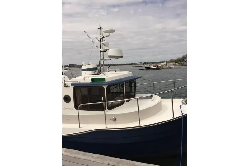 Slide: The Image of 2007 Ranger Tugs R-25 SC boat docked by the waterfront. - 9