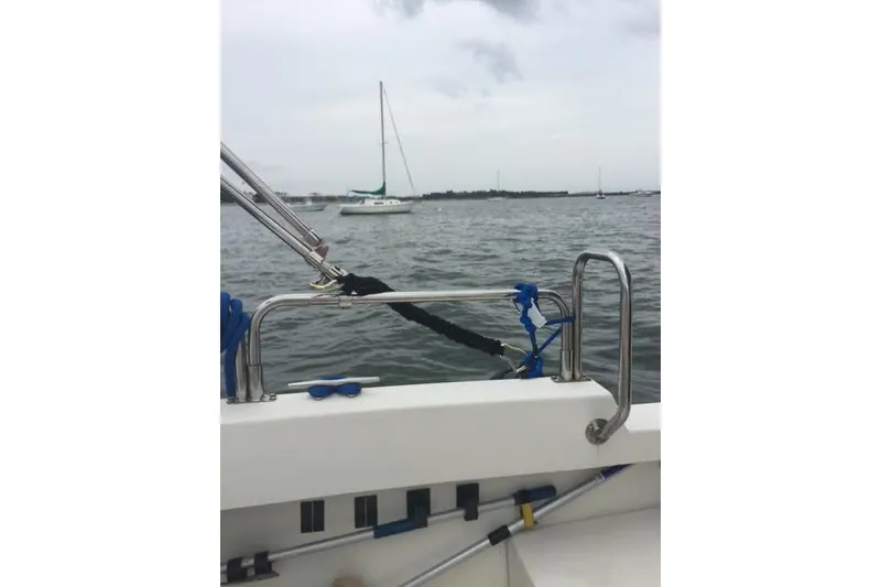 Slide: The Image of 2007 Ranger Tugs R-25 SC boat on water, with sailboats in the background. - 10