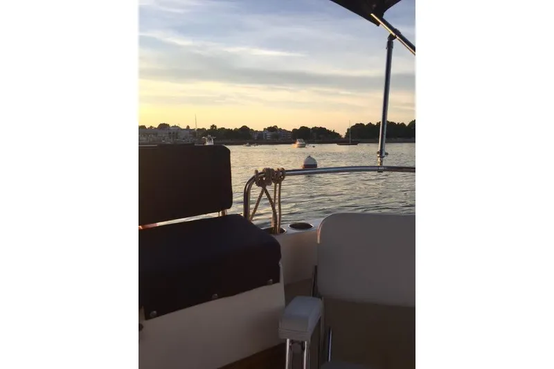 Slide: The Image of 2007 Ranger Tugs R-25 SC boat interior with scenic waterfront view at sunset. - 11