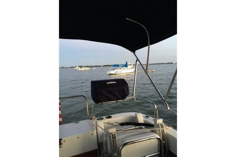 Slide: The Image of 2007 Ranger Tugs R-25 SC boat view with other boats on calm water. - 12