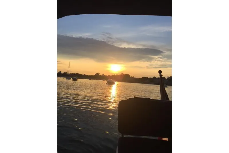 Slide: The Image of Sunset view from a 2007 Ranger Tugs R-25 SC boat on a calm lake. - 20