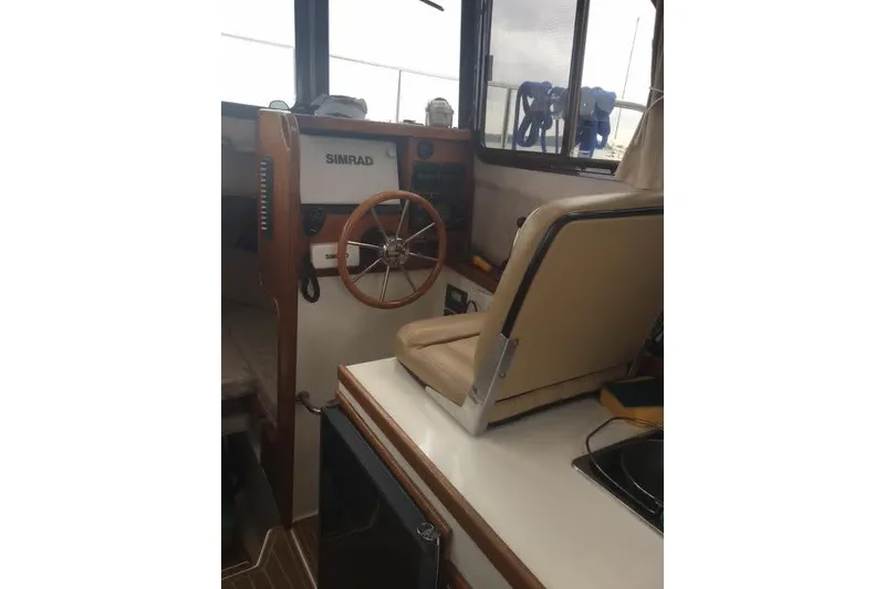 Slide: The Image of 2007 Ranger Tugs R-25 SC helm with steering wheel and navigation equipment. - 23