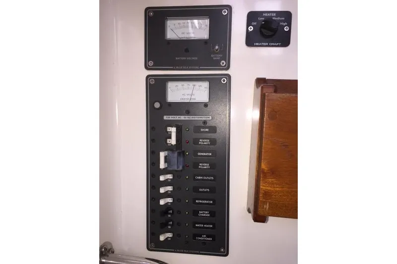 Slide: The Image of Electrical control panel on a 2007 Ranger Tugs R-25 SC boat, featuring various switches and meters. - 27