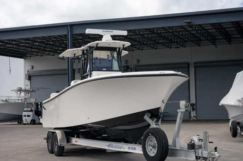 The Image of 2025 SeaVee 290B boat on trailer in marina setting. - 1