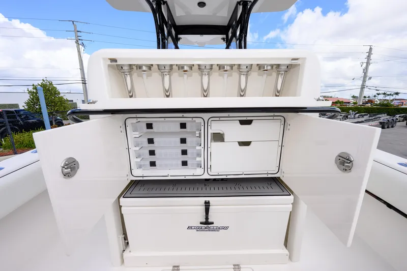 Slide: The Image of 2025 SeaVee 290B boat with open storage compartments and rod holders. - 10