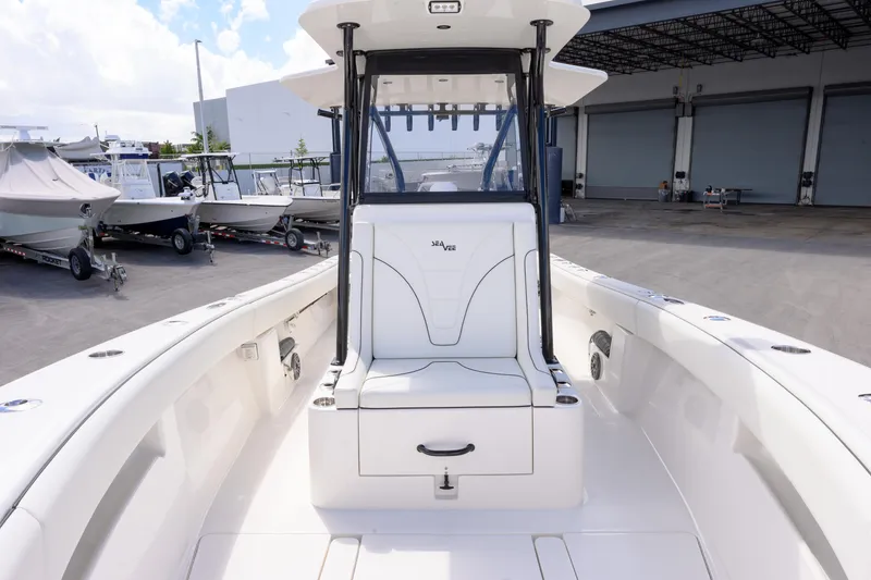 Slide: The Image of 2025 SeaVee 290B boat interior, featuring sleek white seating and spacious deck. - 13
