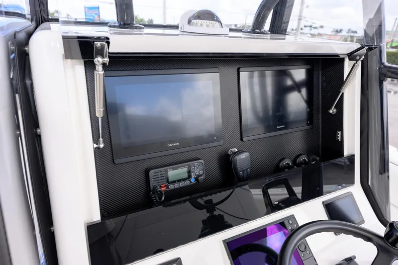 Slide: The Image of 2025 SeaVee 290B boat dashboard with dual Garmin displays and communication equipment. - 6