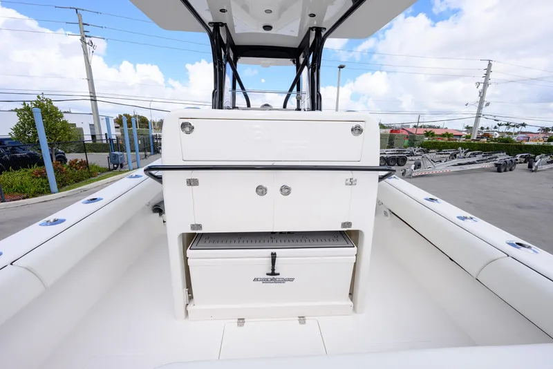 Slide: The Image of 2025 SeaVee 290B boat interior with storage compartments and seating, under a clear blue sky. - 7