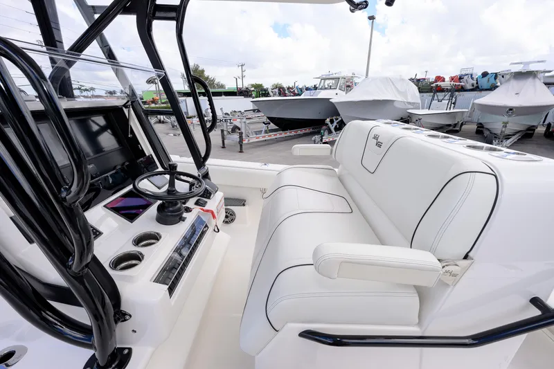 Slide: The Image of 2025 SeaVee 290B boat interior with white seating and steering console. - 8