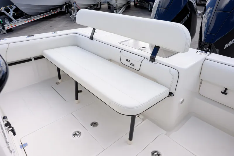 Slide: The Image of 2025 SeaVee 290B boat interior with white seating and Mercury engines. - 9