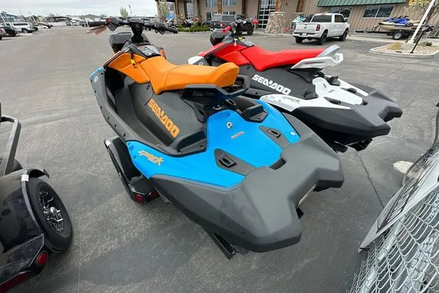 Slide: The Image of 2026 Sea-Doo PWC SPARK TRIXX 90 in blue and orange on parking lot. - 4