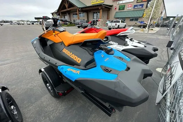 Slide: The Image of 2026 Sea-Doo SPARK TRIXX 90 jet ski displayed in parking lot. - 5