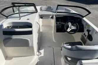 Slide: The Image of 2022 Bayliner VR6 Bowrider OB interior with steering wheel and seating area. - 10
