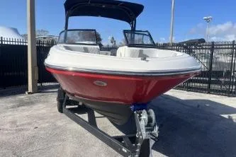 Slide: The Image of 2022 Bayliner VR6 Bowrider OB boat on trailer, red and white exterior. - 3