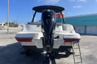 Slide: The Image of 2022 Bayliner VR6 Bowrider OB with outboard motor, parked outdoors. - 6
