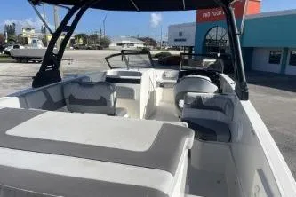 Slide: The Image of 2022 Bayliner VR6 Bowrider OB with spacious seating and modern design in a marina setting. - 7