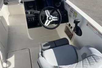 Slide: The Image of 2022 Bayliner VR6 Bowrider OB cockpit with steering wheel and seating. - 9