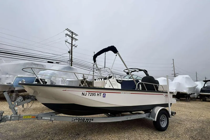 The Image of 2021 Boston Whaler 170 Montauk boat on trailer, parked outdoors. - 1