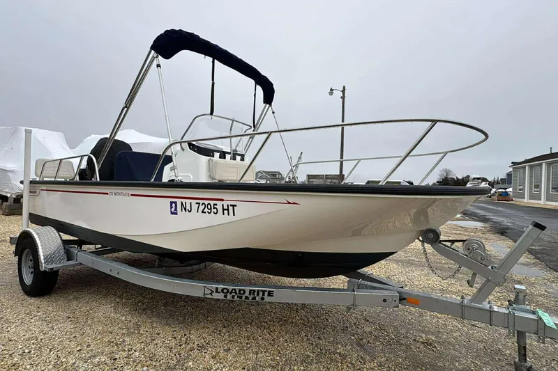 Slide: The Image of 2021 Boston Whaler 170 Montauk boat on trailer, parked outdoors. - 3