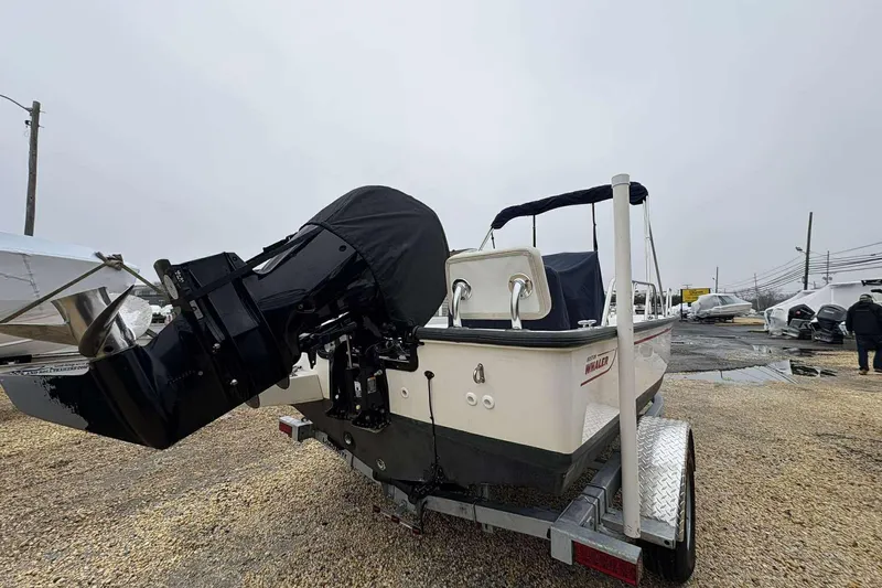 Slide: The Image of 2021 Boston Whaler 170 Montauk boat on trailer, featuring covered outboard motor. - 8