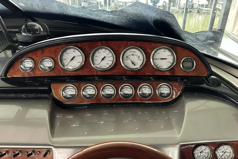 Slide: The Image of Dashboard of a 2004 Cobalt 360 Cruiser with wood paneling and multiple gauges. - 15